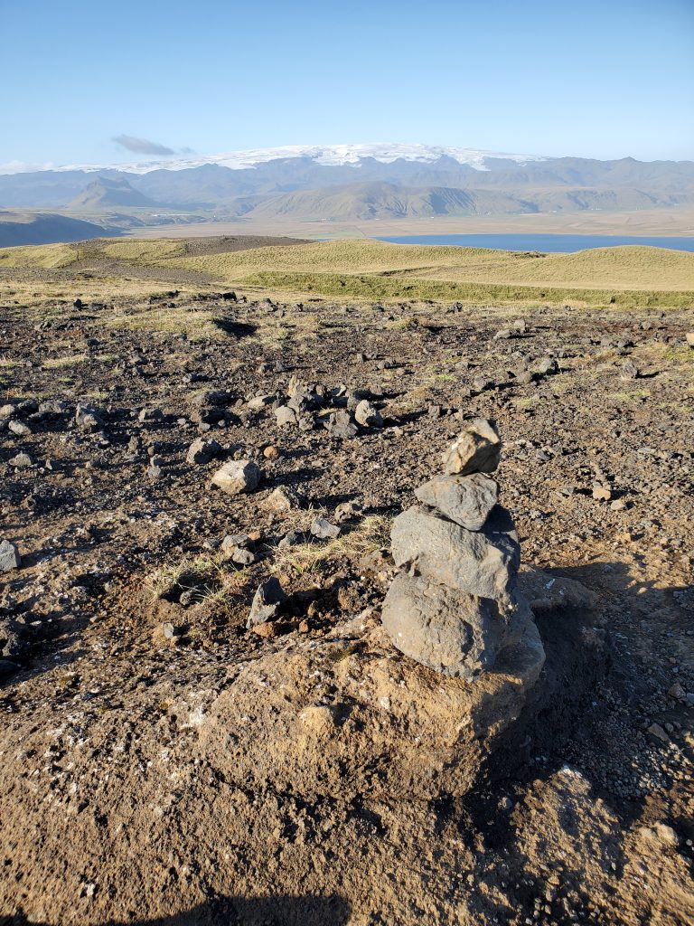 stacked rocks with Katla in the background