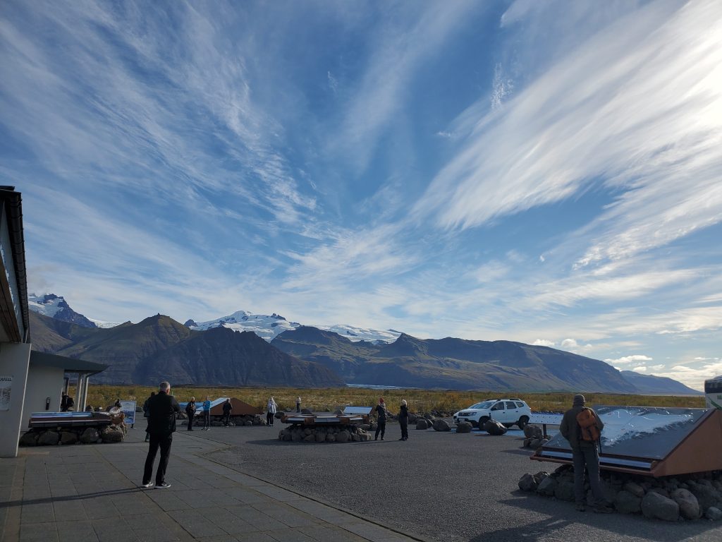 visitor's center signs with the glacier in the background