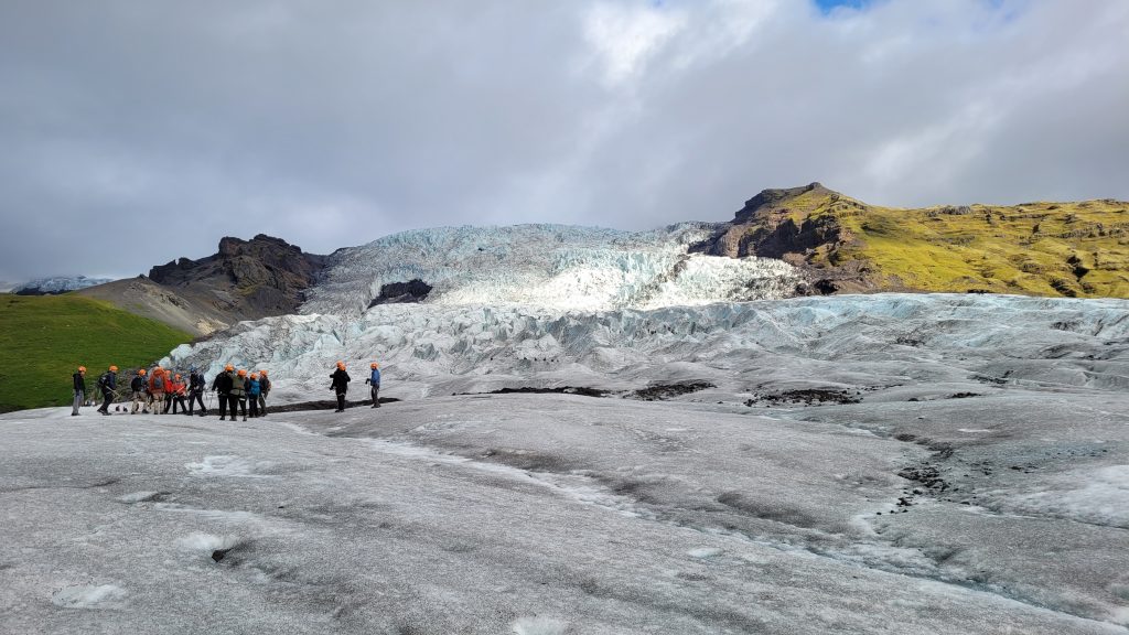 glacier with people walking on it