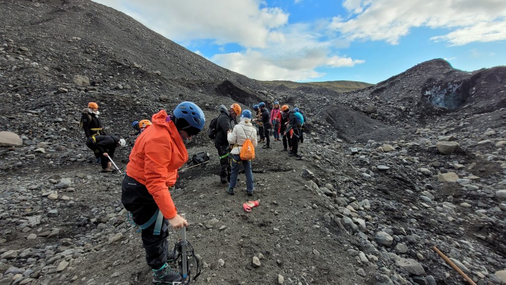 people gathered on black gravel of mountain