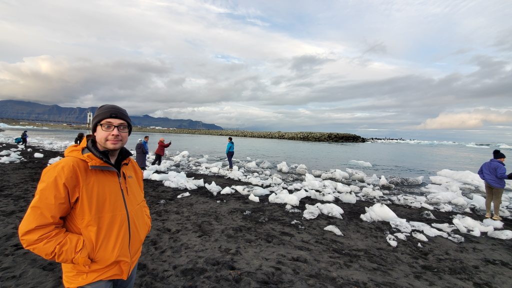 Graham walks along the beach with people and ice chunks everywhere