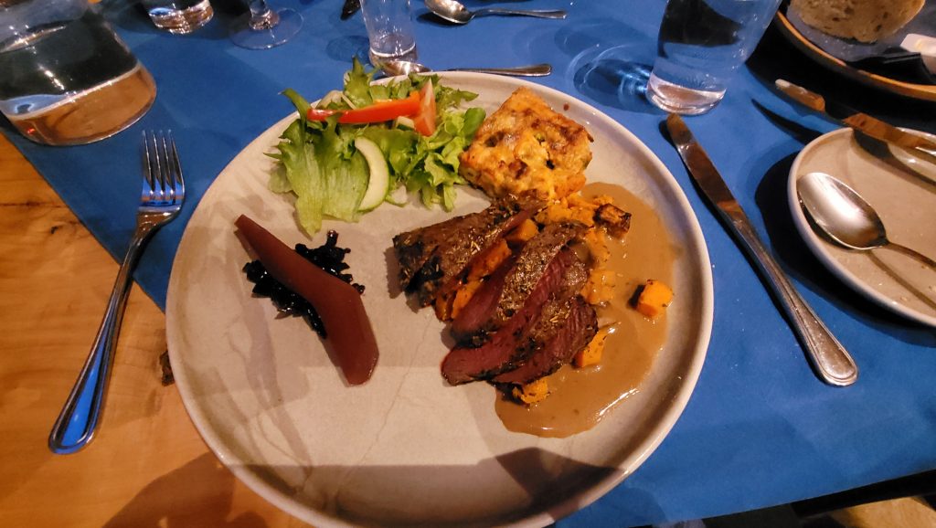 steak with salad and casserole