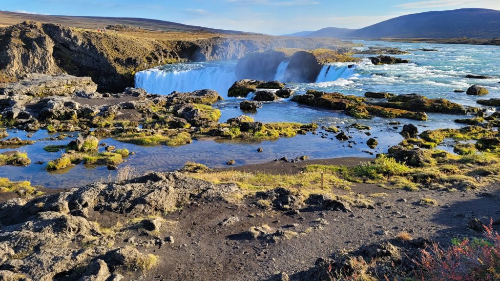 above the waterfall are pools of water