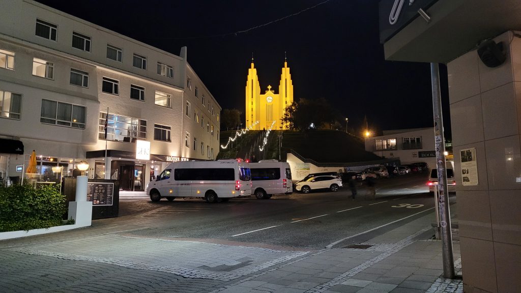 church on hill in distance at night.