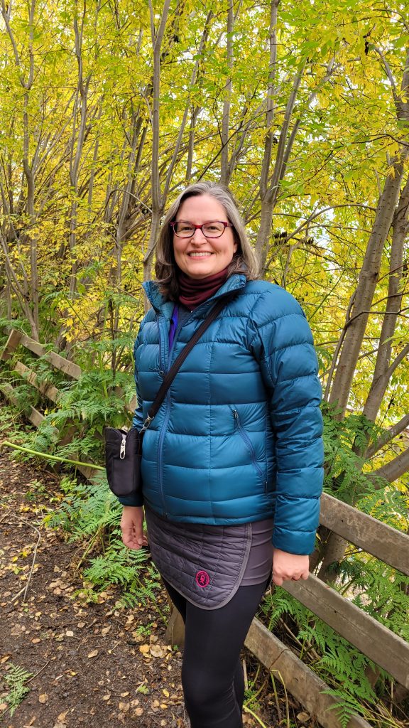 fall leaves on trees behind a person