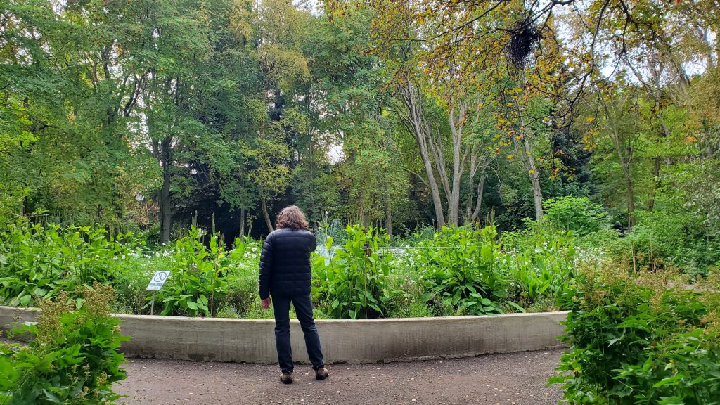 Graham in front of concrete-walled garden