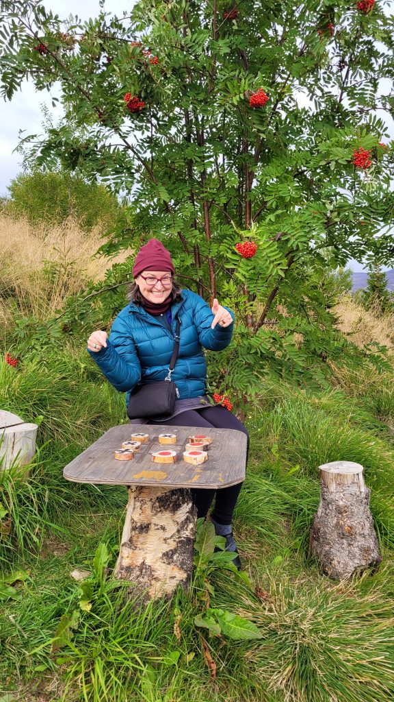 Susan sitting on wooden stools with a game board