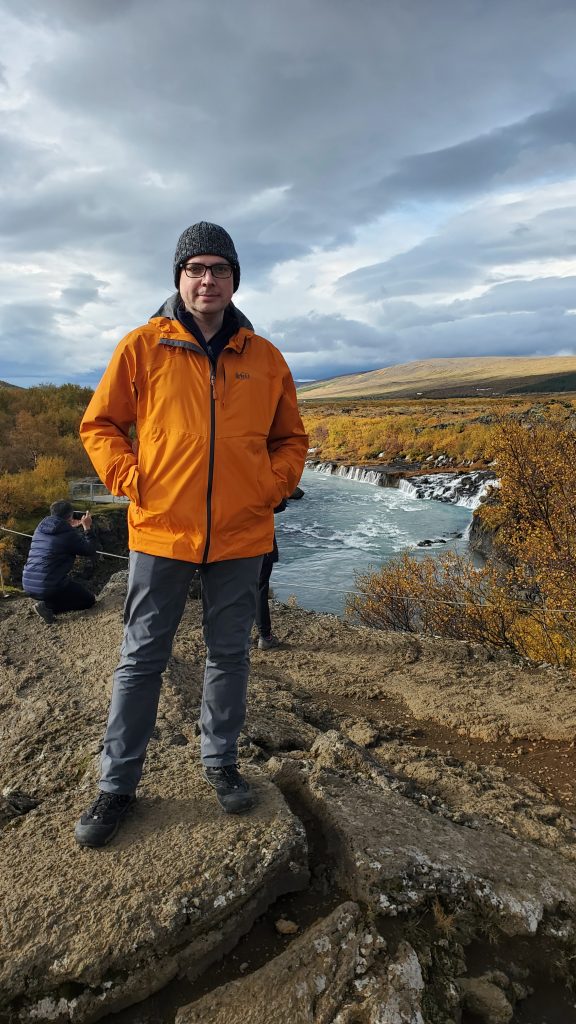 Graham standing in front of waterfalls