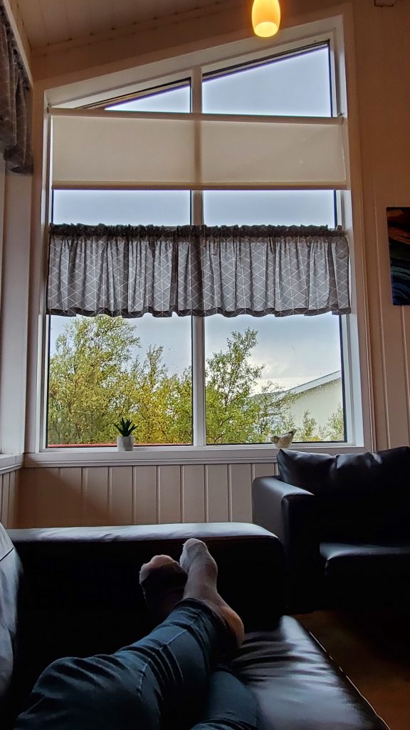 window view with person laying on couch