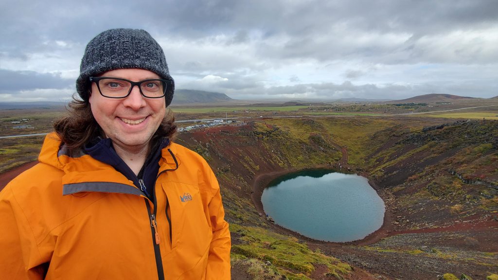 Graham with a volcanic lake behind him