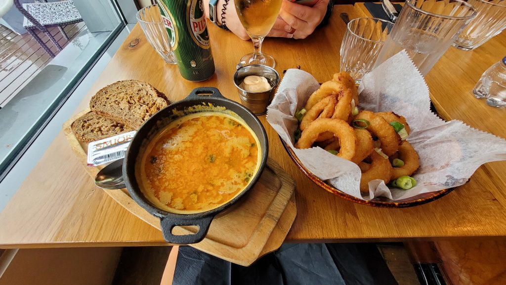 seafood soup, rye bread, and onion rings