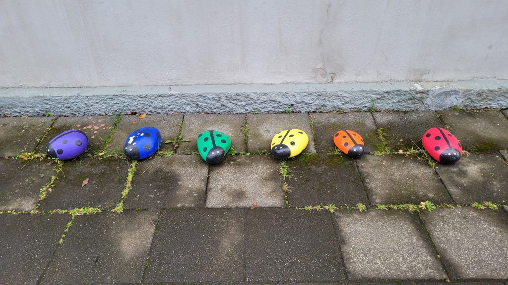 ladybugs painted in rainbow colors